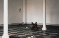 installation view of cassette player with chirping birds, super 8 projection and poster searching for an apartment